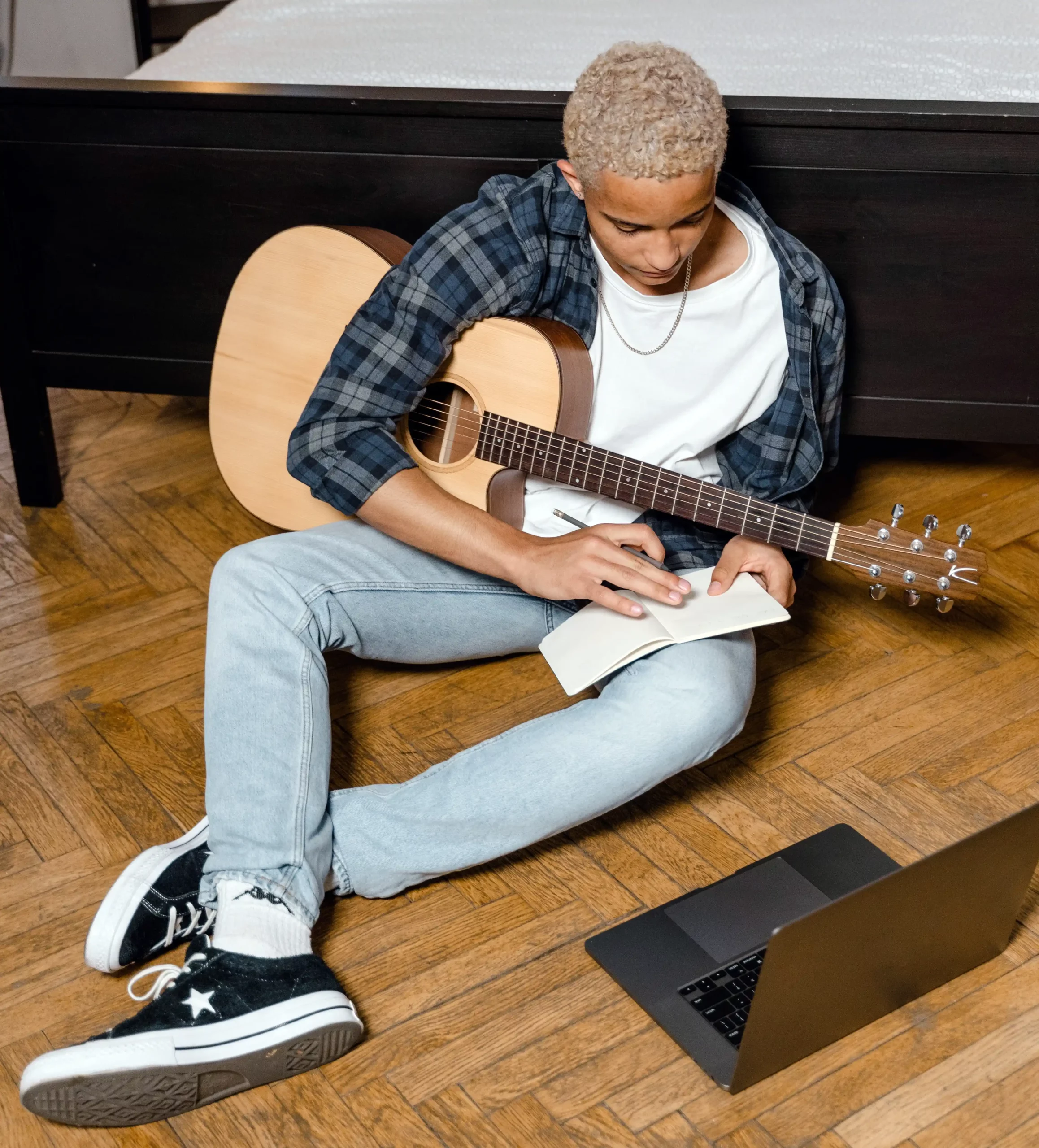Musician with a guitar planning his social media music marketing strategy